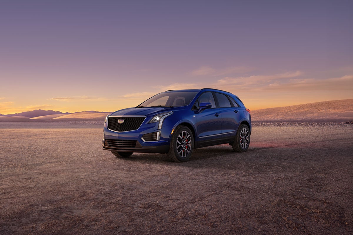 The Dark Moon Blue Metallic Cadillac XT5 Parked During the Sunset in Desert