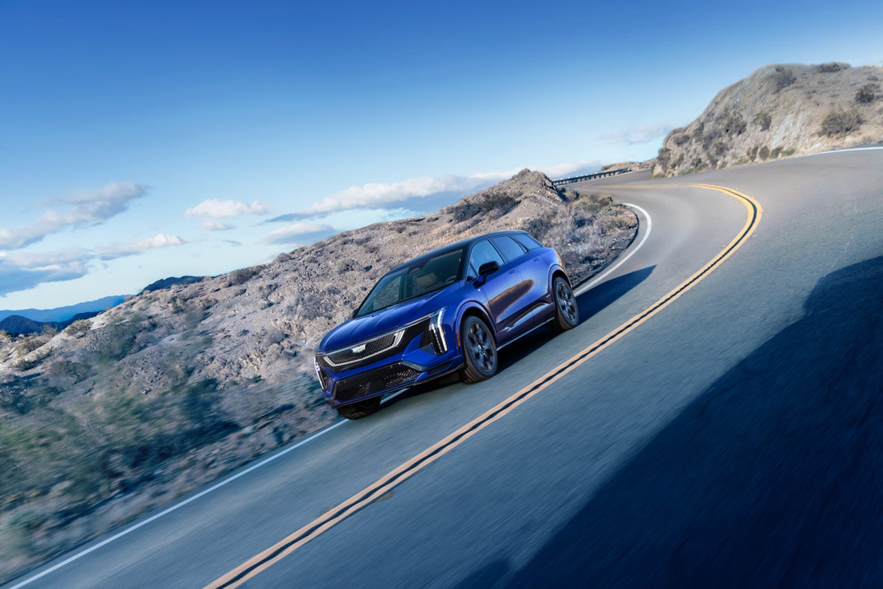 Close-up of a Woman Walking Past the 2025 Cadillac XT4 Grille