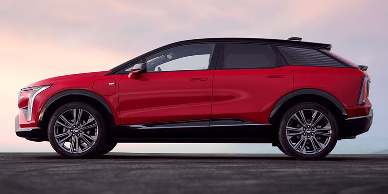 Red Cadillac SUV shown in side profile against a sunset sky